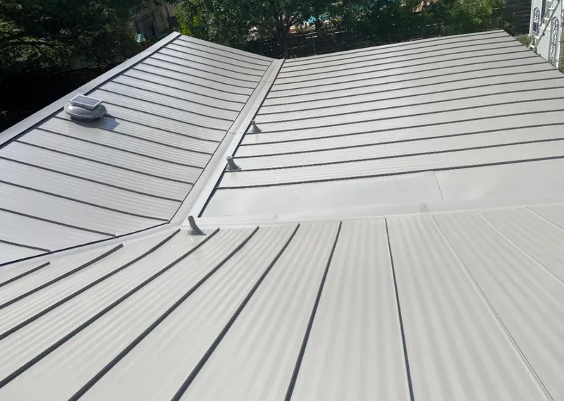 Solar attic fan installed on a metal roof for Roof Ventilation in Oshtemo